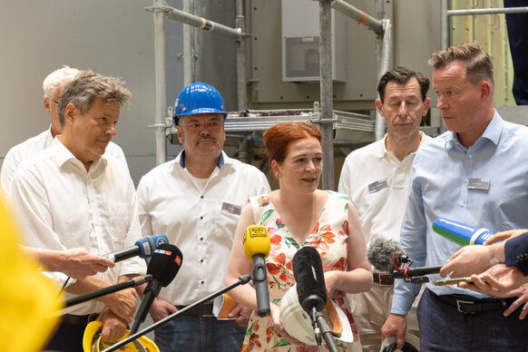 Während des Rundgangs durch das Heizkraftwerk Nord der Stadtwerke Bonn gaben Minister Robert Habeck, Oberbürgermeisterin Katja Dörner und Olaf Hermes, Vorsitzender der SWB-Geschäftsführung, (vorne, v.l.) den Medien kurze Statements.