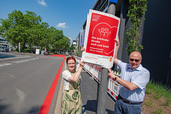 Oberbürgermeisterin Katja Dörner und Stadtbaurat Helmut Wiesner hängen ein Plakat auf