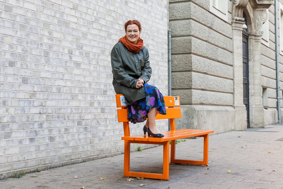 Oberbürgermeisterin Katja Dörner auf einer orangen Bank