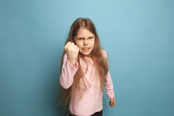 The cry. Teen girl on a blue background. Facial expressions and people emotions concept